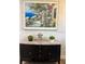 Artwork above the dark wood credenza adds elegance to the room at 8623 Snowy Owl Way, Tampa, FL 33647