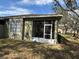 Exterior of home with view of screened lanai and well-maintained backyard at 8623 Snowy Owl Way, Tampa, FL 33647