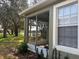 Screened lanai and backyard with partial view of lake at 8623 Snowy Owl Way, Tampa, FL 33647