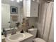 Fresh bathroom design with a white shower curtain, cabinets and matching accessories at 8623 Snowy Owl Way, Tampa, FL 33647