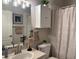 Clean bathroom featuring white cabinets and decorative shower curtain at 8623 Snowy Owl Way, Tampa, FL 33647