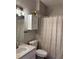 Bathroom featuring sink, toilet, cabinet, and bathtub with shower at 8623 Snowy Owl Way, Tampa, FL 33647