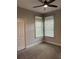 Comfortable bedroom featuring two large windows, neutral carpeting, and closet at 8623 Snowy Owl Way, Tampa, FL 33647