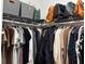 Walk in closet featuring clothing racks, shelving, handbags, and various articles of clothing at 8623 Snowy Owl Way, Tampa, FL 33647