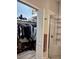 Walk in closet featuring clothing racks, shelving, handbags, shoes and a view to the shower at 8623 Snowy Owl Way, Tampa, FL 33647