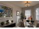 Formal dining room with chandelier and decorative painting adding elegance to the home at 8623 Snowy Owl Way, Tampa, FL 33647