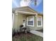 Covered front entrance with charming front door and lush landscaping at 8623 Snowy Owl Way, Tampa, FL 33647