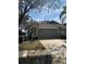 Single Gathering home with lush green lawn, a driveway and an American flag at 8623 Snowy Owl Way, Tampa, FL 33647
