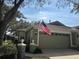 Charming home with two-car garage, well-maintained lawn and American flag at 8623 Snowy Owl Way, Tampa, FL 33647