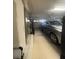 Spacious garage featuring a car parked inside, along with a garage door and visible utilities at 8623 Snowy Owl Way, Tampa, FL 33647