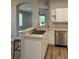 Kitchen featuring stainless steel sink and dishwasher with a view of the living room at 8623 Snowy Owl Way, Tampa, FL 33647