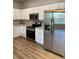 Well-equipped kitchen featuring stainless steel appliances and white cabinets at 8623 Snowy Owl Way, Tampa, FL 33647