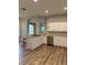 Open kitchen with stainless steel appliances, white cabinets, and bar seating at 8623 Snowy Owl Way, Tampa, FL 33647