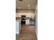 Well-lit kitchen featuring stainless steel appliances, recessed lights, and white cabinets at 8623 Snowy Owl Way, Tampa, FL 33647