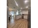 Spacious kitchen featuring stainless appliances, white cabinetry and an island with seating at 8623 Snowy Owl Way, Tampa, FL 33647