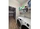 Laundry room featuring easy access to the kitchen with updated appliances and shelving at 8623 Snowy Owl Way, Tampa, FL 33647