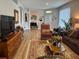 Spacious living room featuring hardwood floors and lots of natural light and comfortable seating at 8623 Snowy Owl Way, Tampa, FL 33647