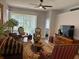 Living room boasting with hardwood floors, comfortable seating, and a ceiling fan at 8623 Snowy Owl Way, Tampa, FL 33647