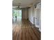 Bright living room featuring hardwood floors, ceiling fan, and sliding glass doors to the outside at 8623 Snowy Owl Way, Tampa, FL 33647