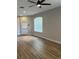Bright living room with hardwood flooring and a ceiling fan at 8623 Snowy Owl Way, Tampa, FL 33647