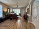 Open-concept living room featuring hardwood floors, comfortable seating, and lots of natural light at 8623 Snowy Owl Way, Tampa, FL 33647