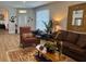 Spacious living room featuring hardwood floors and lots of natural light and comfortable seating at 8623 Snowy Owl Way, Tampa, FL 33647