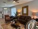 Open-concept living room with area rug, plush seating, and natural light, offering a comfortable living space at 8623 Snowy Owl Way, Tampa, FL 33647