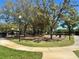 A charming park featuring lush trees, winding paths, a playground, benches, and inviting green spaces at 8623 Snowy Owl Way, Tampa, FL 33647