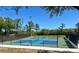 An outdoor pickleball court with well-maintained blue and green surface, net, and surrounding greenery at 8623 Snowy Owl Way, Tampa, FL 33647