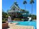 A community swimming pool with a water slide and lifeguard stand and beautiful landscaping on a sunny day at 8623 Snowy Owl Way, Tampa, FL 33647