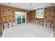 Living room with exposed studs and in-wall insulation, ready for personalization with a large sliding glass door at 6805 Holmes Blvd, Holmes Beach, FL 34217