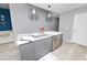 Kitchen island with gray cabinetry, seating, and modern appliances at 777 N Ashley Dr # 2313, Tampa, FL 33602