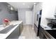 Modern kitchen with stainless appliances, waterfall countertop and pendant lighting at 777 N Ashley Dr # 2313, Tampa, FL 33602