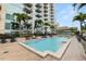 Beautiful pool deck with palm trees and clear blue water at 777 N Ashley Dr # 2313, Tampa, FL 33602