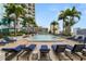 Community pool with lounge chairs and clear blue water surrounded by Palm Trees at 777 N Ashley Dr # 2313, Tampa, FL 33602