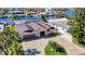 Beautiful aerial view of a waterfront home with a paved driveway, lush landscaping, and neighborhood access to the water at 5509 Pilots Pl, New Port Richey, FL 34652