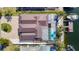 Bird's-eye view of a well-maintained property with a pool, boat dock, and metal roof, highlighting its prime location at 5509 Pilots Pl, New Port Richey, FL 34652