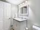 Bathroom features modern vanity with granite counters, new fixtures and white cabinets at 5509 Pilots Pl, New Port Richey, FL 34652