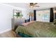 Bright bedroom with a large bed, dresser, and natural light from the window at 5509 Pilots Pl, New Port Richey, FL 34652