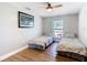 Bedroom with wood-look flooring, large window, and comfortable twin beds at 5509 Pilots Pl, New Port Richey, FL 34652