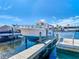 Dock with a boat on a lift, kayak, and serene water, creating a perfect spot for boating enthusiasts at 5509 Pilots Pl, New Port Richey, FL 34652