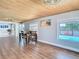 The dining room features a wood ceiling, wood floors, and views of the canal at 5509 Pilots Pl, New Port Richey, FL 34652