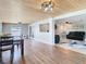 The dining room with view into the living room features a wood ceiling and wood floors at 5509 Pilots Pl, New Port Richey, FL 34652
