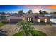 Charming exterior view of home with a circular drive and mature palm tree in yard at 5509 Pilots Pl, New Port Richey, FL 34652