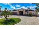 Inviting single-story home showcasing a lush lawn, circular driveway, and distinctive architectural details at 5509 Pilots Pl, New Port Richey, FL 34652