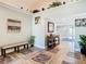 Bright foyer featuring decorative accents, bench seating, and attractive tile flooring at 5509 Pilots Pl, New Port Richey, FL 34652