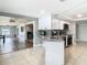 Open kitchen with white cabinets, granite counters and stainless appliances at 5509 Pilots Pl, New Port Richey, FL 34652