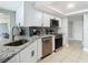 Modern kitchen features stainless steel appliances, granite countertops, and stylish backsplash at 5509 Pilots Pl, New Port Richey, FL 34652