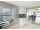 Bright kitchen with white cabinets, granite counters and a view of the canal at 5509 Pilots Pl, New Port Richey, FL 34652