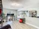Spacious living room has wood floors, a comfortable chair, and a workspace at 5509 Pilots Pl, New Port Richey, FL 34652